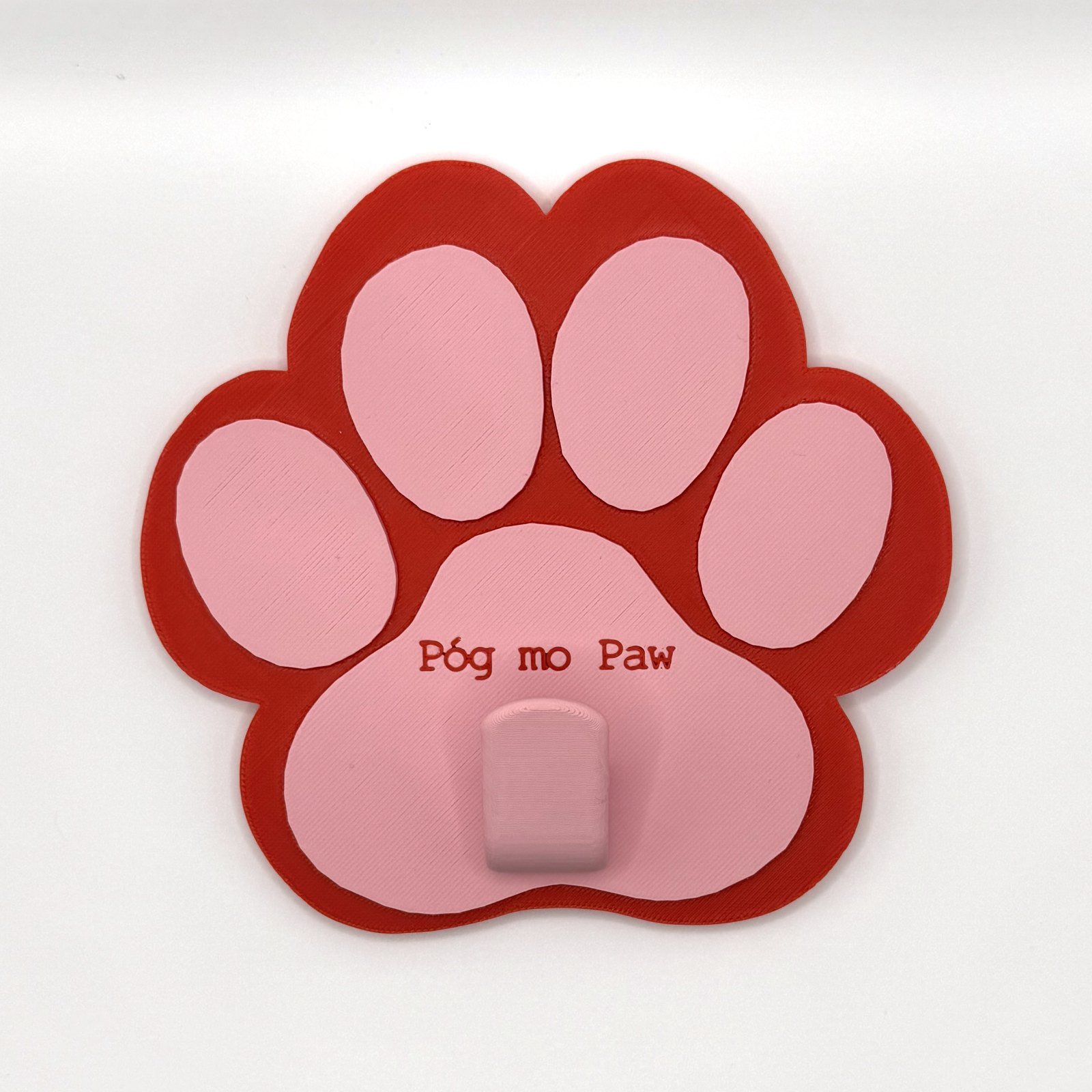 Standard paw-shaped leash holder in red with pink pads and a central pink hook, 3D printed Póg mo Paw hallway organiser