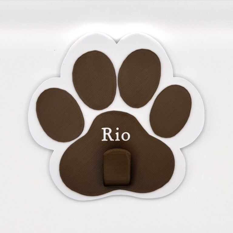 Personalised paw-shaped lead holder in white and brown with the name Rio
