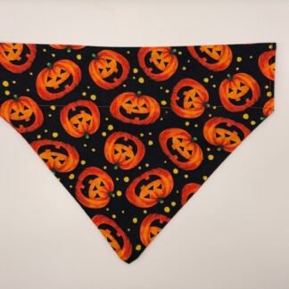Jack O'Lantern Halloween dog bandana black fabric with repeating orange pumpkin jack-o'-lantern faces and yellow dots